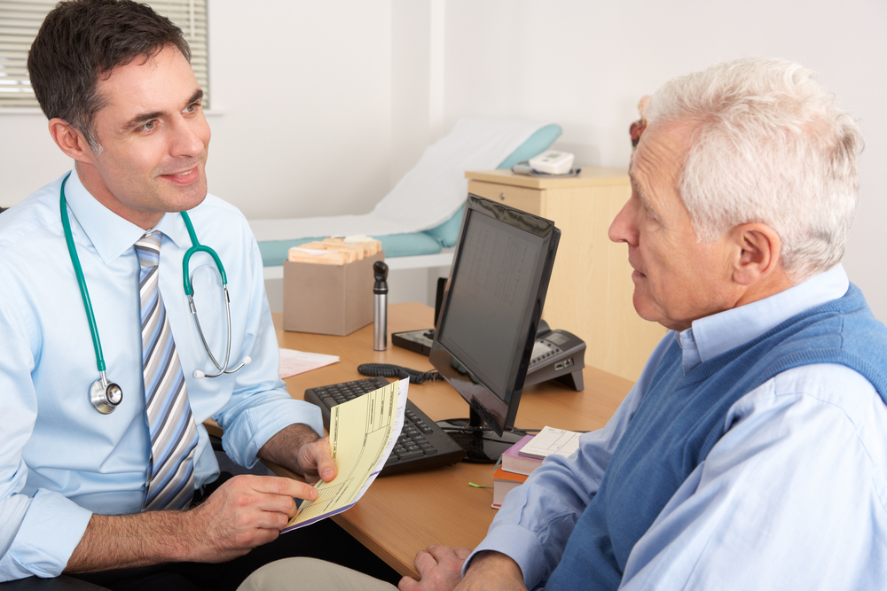 older man talking to doctor.