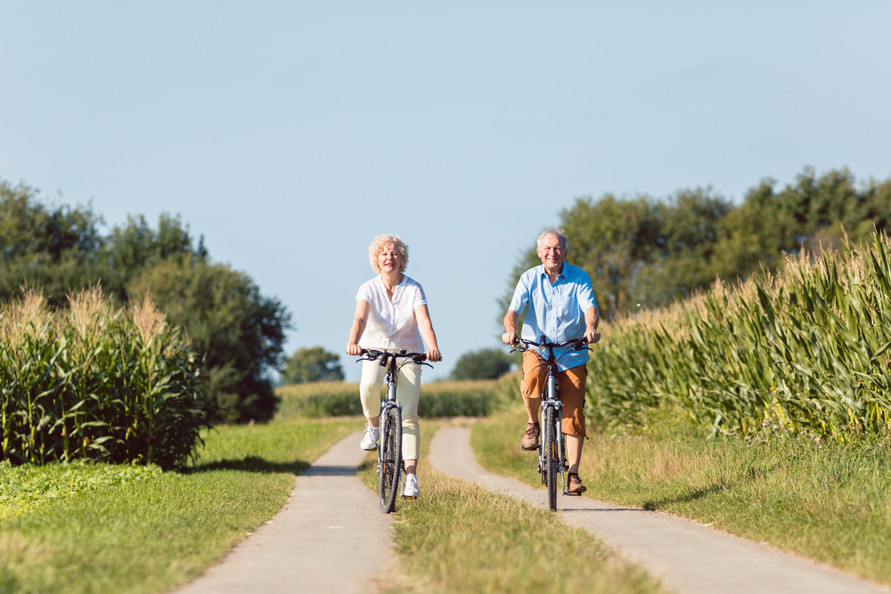 Older couple riding bikes and staying active.
