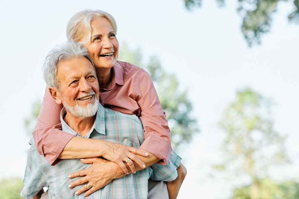 older couple smiling.